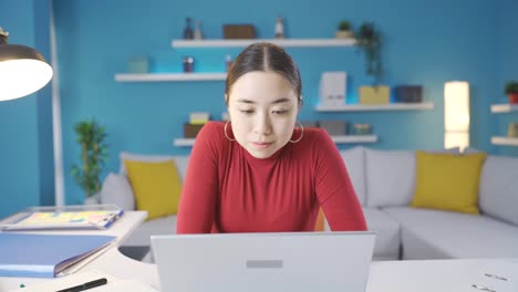 Asian-young-woman-working-from-home-lost-in-thought-about-what-to-do.